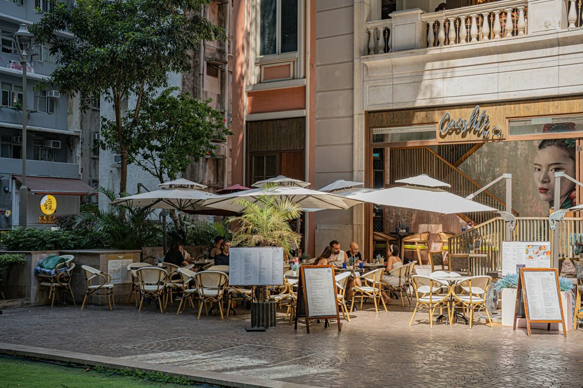 Outdoor café tables shaded by umbrellas